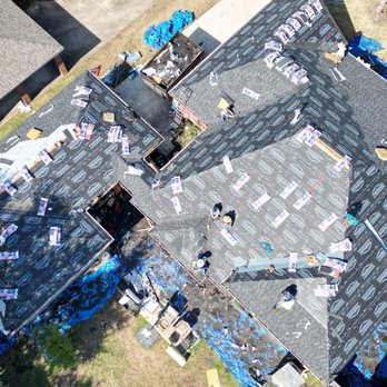 Aerial drone view of Ronnie Roofer crew installing shingles on a Houston home